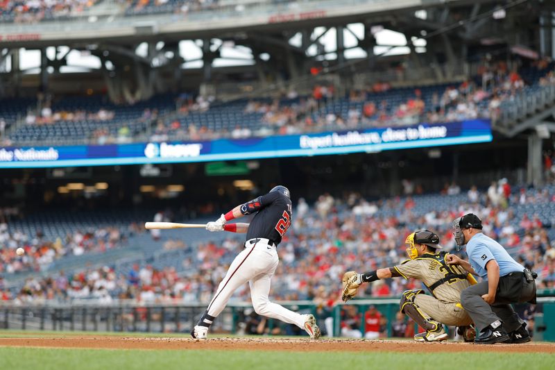 Jul 24, 2024; Washington, District of Columbia, USA; Washington Nationals outfielder Lane Thomas (28) singles against the San Diego Padres during the first inning at Nationals Park. Mandatory Credit: Geoff Burke-USA TODAY Sports