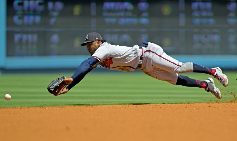 Sep 3, 2023; Los Angeles, California, USA;  Los Angeles Dodgers catcher Will Smith (16) singles past Atlanta Braves second baseman Ozzie Albies (1) in the first inning at Dodger Stadium. Mandatory Credit: Jayne Kamin-Oncea-USA TODAY Sports