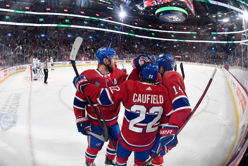 Apr 6, 2024; Montreal, Quebec, CAN; Montreal Canadiens forward Cole Caufield (22) celebrates with teammates defenseman Mike Matheson (8) and forward Nick Suzuki (14) after scoring a goal against the Toronto Maple Leafs during the second period at the Bell Centre. Mandatory Credit: Eric Bolte-USA TODAY Sports