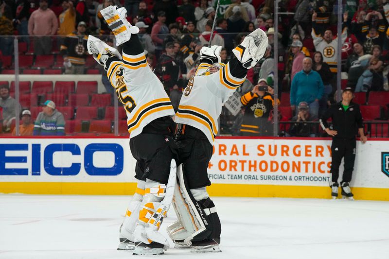 Mar 26, 2023; Raleigh, North Carolina, USA;  Boston Bruins goaltender Jeremy Swayman (1) and Boston Bruins goaltender Linus Ullmark (35) celebrate their victory against the Carolina Hurricanes in the shootout at PNC Arena. Mandatory Credit: James Guillory-USA TODAY Sports