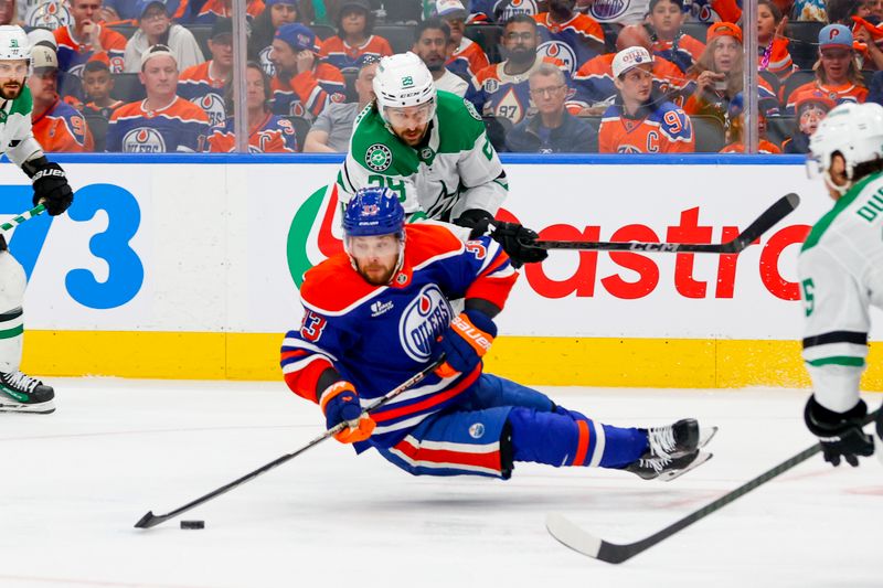 May 27, 2025; Edmonton, Alberta, CAN; Edmonton Oilers left wing Viktor Arvidsson (33) is tripped up in front of Dallas Stars defenseman Alexander Petrovic (28) during the third period in game four of the Western Conference Final of the 2025 Stanley Cup Playoffs at Rogers Place. Mandatory Credit: Perry Nelson-Imagn Images