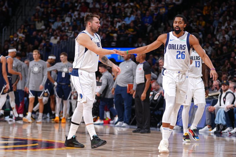 DENVER, CO - NOVEMBER 10:  Luka Doncic #77 and Spencer Dinwiddie #26 of the Dallas Mavericks high five during the gameduring the game against the Denver Nuggets during a regular season game on November 10, 2024 at Ball Arena in Denver, Colorado. NOTE TO USER: User expressly acknowledges and agrees that, by downloading and/or using this Photograph, user is consenting to the terms and conditions of the Getty Images License Agreement. Mandatory Copyright Notice: Copyright 2024 NBAE (Photo by Bart Young/NBAE via Getty Images)