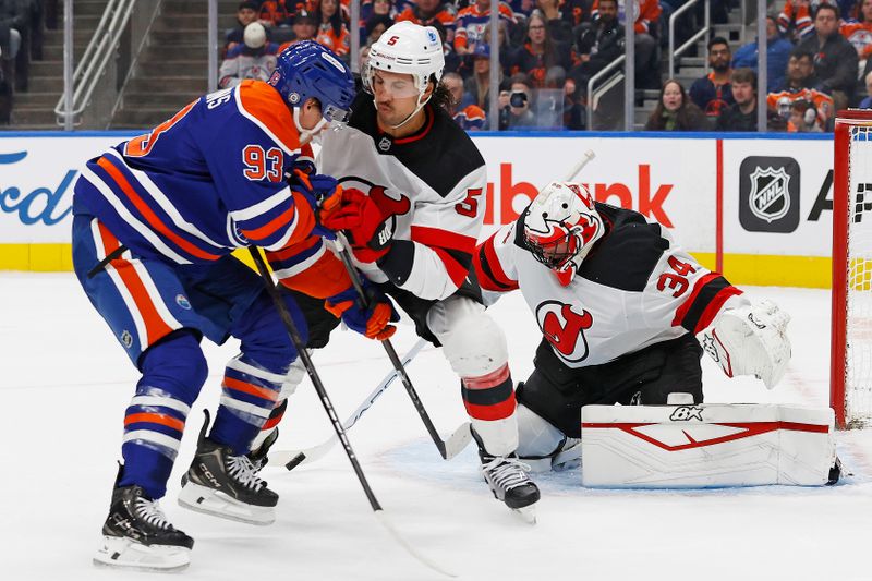 Nov 4, 2024; Edmonton, Alberta, CAN; Edmonton Oilers forward Ryan Nugent-Hopkins (93) and New Jersey Devils defensemen Brendan Dillon (5) battle for a loose puck in front of goaltender Jake Allen (34) during the first period at Rogers Place. Mandatory Credit: Perry Nelson-Imagn Images