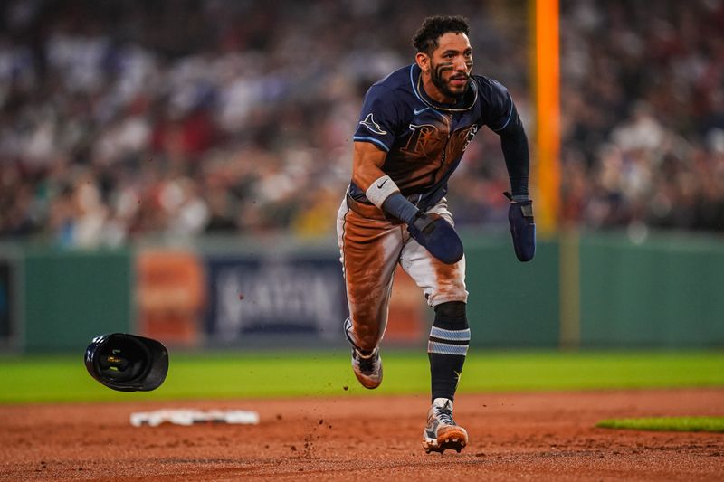 Jun 10, 2025; Boston, Massachusetts, USA; Tampa Bay Rays shortstop José Caballero (77) steals third base on a pass ball against the Boston Red Sox in the fifth inning at Fenway Park. Mandatory Credit: David Butler II-Imagn Images