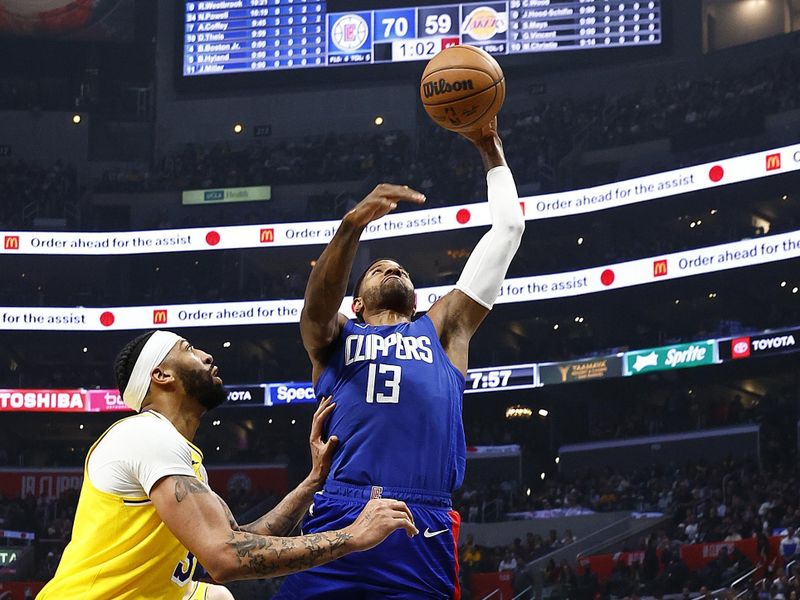 LOS ANGELES, CALIFORNIA - JANUARY 23:  Paul George #13 of the LA Clippers takes a shot against Anthony Davis #3 of the Los Angeles Lakers in the first half at Crypto.com Arena on January 23, 2024 in Los Angeles, California.  NOTE TO USER: User expressly acknowledges and agrees that, by downloading and/or using this photograph, user is consenting to the terms and conditions of the Getty Images License Agreement.  (Photo by Ronald Martinez/Getty Images)