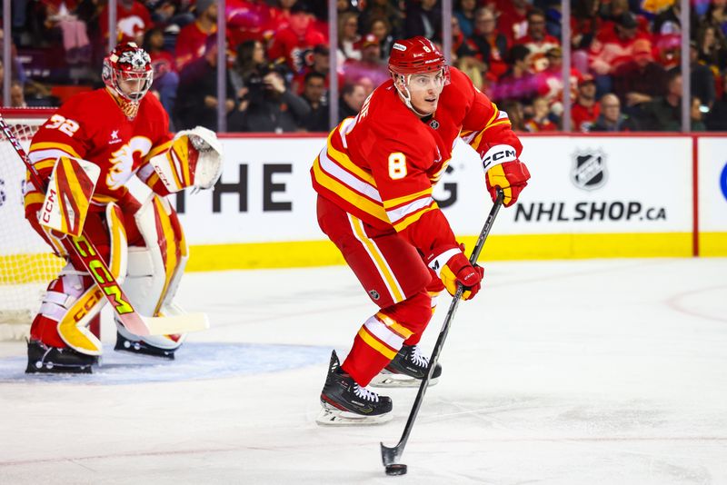 Nov 11, 2024; Calgary, Alberta, CAN; Calgary Flames defenseman Tyson Barrie (8) controls the puck in front of goaltender Dustin Wolf (32) during the first period against the Los Angeles Kings at Scotiabank Saddledome. Mandatory Credit: Sergei Belski-Imagn Images