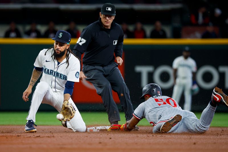 May 31, 2025; Seattle, Washington, USA; Minnesota Twins second baseman Willi Castro (50) steals second base before Seattle Mariners shortstop J.P. Crawford (3) can apply a tag during the second inning at T-Mobile Park. Mandatory Credit: Joe Nicholson-Imagn Images
