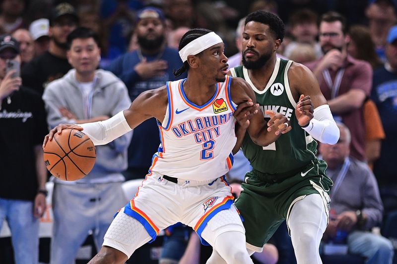 OKLAHOMA CITY, OKLAHOMA - APRIL 12: Shai Gilgeous-Alexander #2 of the Oklahoma City Thunder handles the ball in front of Jaylin Galloway #6 of the Milwaukee Bucks during the first half at Paycom Center on April 12, 2024 in Oklahoma City, Oklahoma. NOTE TO USER: User expressly acknowledges and agrees that, by downloading and or using this Photograph, user is consenting to the terms and conditions of the Getty Images License Agreement. (Photo by Joshua Gateley/Getty Images)