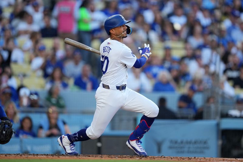 Jun 15, 2024; Los Angeles, California, USA; Los Angeles Dodgers shortstop Mookie Betts (50) bats in the third inning against the Kansas City Royals at Dodger Stadium. Mandatory Credit: Kirby Lee-USA TODAY Sports