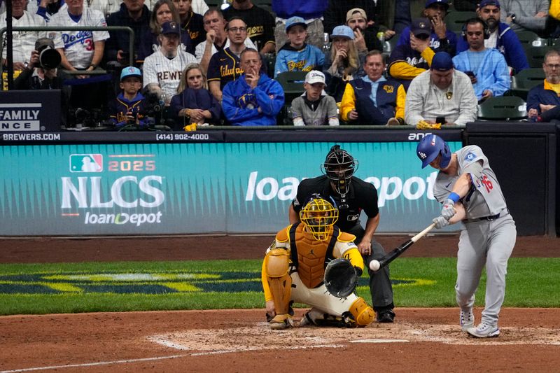 Oct 14, 2025; Milwaukee, Wisconsin, USA; Los Angeles Dodgers catcher Will Smith (16) hits a single against the Milwaukee Brewers in the eighth inning during game two of the NLCS round for the 2025 MLB playoffs at American Family Field. Mandatory Credit: Michael McLoone-Imagn Images