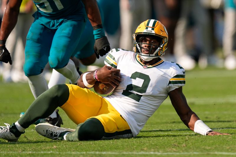 Green Bay Packers' Malik Willis runs for a first down during the second half of an NFL football game against the Jacksonville Jaguars Sunday, Oct. 27, 2024, in Jacksonville, Fla. (AP Photo/John Bazemore)