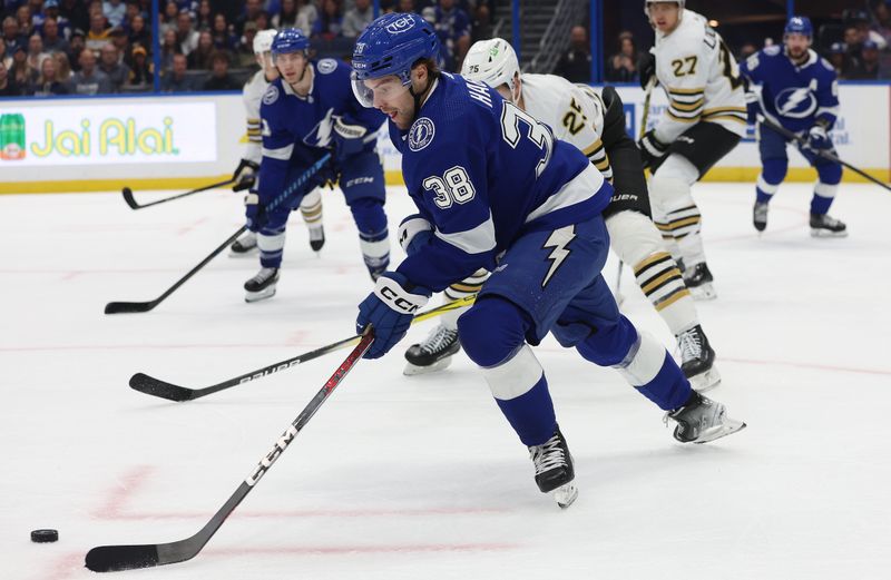 Nov 20, 2023; Tampa, Florida, USA; Tampa Bay Lightning left wing Brandon Hagel (38) skates with the puck against the Boston Bruins during the first period at Amalie Arena. Mandatory Credit: Kim Klement Neitzel-USA TODAY Sports