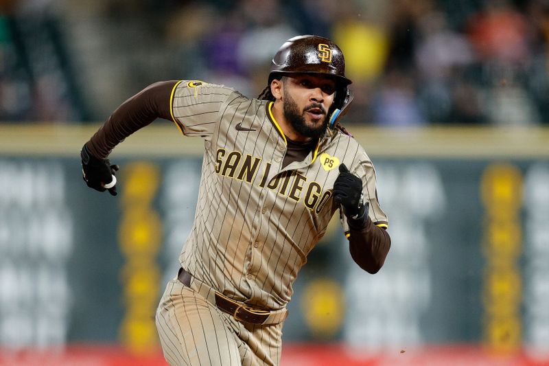 Apr 22, 2024; Denver, Colorado, USA; San Diego Padres right fielder Fernando Tatis Jr. (23) rounds second on a triple in the seventh inning against the Colorado Rockies at Coors Field. Mandatory Credit: Isaiah J. Downing-USA TODAY Sports