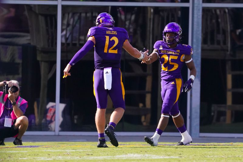 Oct 2, 2021; Greenville, North Carolina, USA;  East Carolina Pirates running back Keaton Mitchell (25) is congratulated by quarterback Holton Ahlers (12) after his touchdown run against the Tulane Green Wave during the first half at Dowdy-Ficklen Stadium. Mandatory Credit: James Guillory-USA TODAY Sports