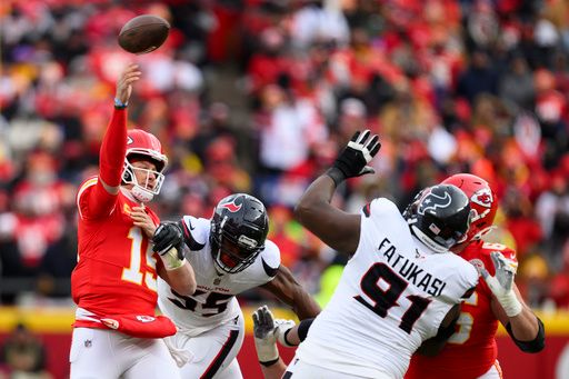 Kansas City Chiefs quarterback Patrick Mahomes (15) throws while under pressure from Houston Texans defensive end Danielle Hunter (55) and Texans defensive tackle Folorunso Fatukasi (91) during the first half of an NFL football divisional playoff game, Saturday, Jan. 18, 2025 in Kansas City, Mo. The Chiefs defeated the Texans by a score of 23-14. (AP Photo/Reed Hoffmann)