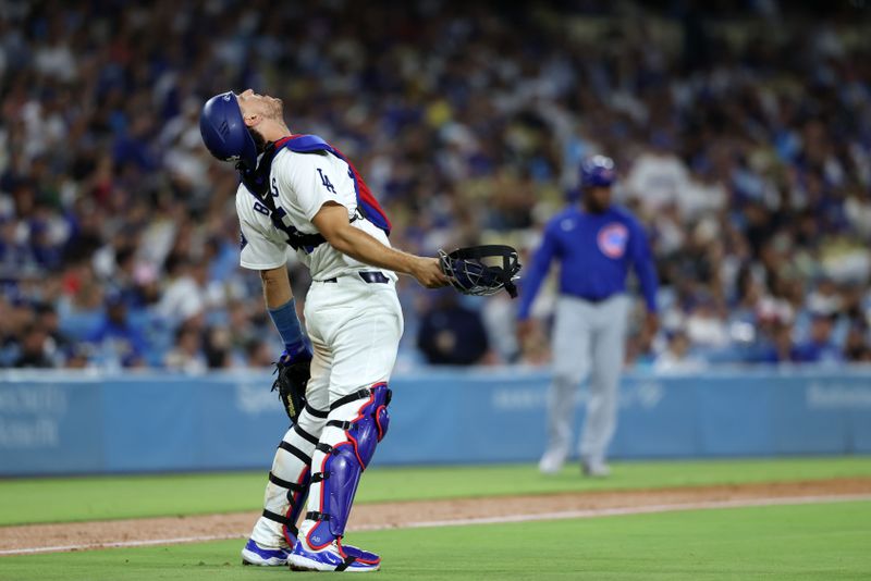 Sep 10, 2024; Los Angeles, California, USA;  Los Angeles Dodgers catcher Austin Barnes (15) reacts after making a throwing error during the eighth inning against the Chicago Cubs at Dodger Stadium. Mandatory Credit: Kiyoshi Mio-Imagn Images