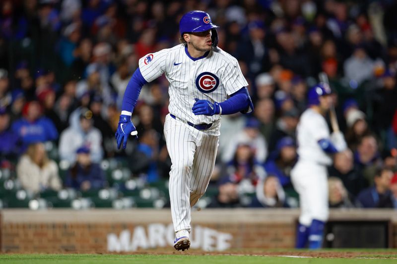 Apr 24, 2024; Chicago, Illinois, USA; Chicago Cubs second base Nico Hoerner (2) runs to first base after hitting a single against the Houston Astros during the fourth inning at Wrigley Field. Mandatory Credit: Kamil Krzaczynski-USA TODAY Sports