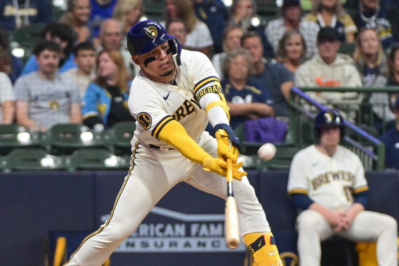 Sep 12, 2023; Milwaukee, Wisconsin, USA; Milwaukee Brewers catcher William Contreras (24) hits a sacrifice fly in the seventh inning against the Miami Marlins at American Family Field. Mandatory Credit: Benny Sieu-USA TODAY Sports