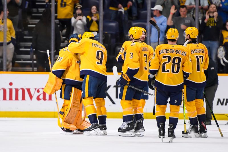 Apr 13, 2024; Nashville, Tennessee, USA;Nashville Predators left wing Filip Forsberg (9) celebrates the win with goaltender Juuse Saros (74) against the Columbus Blue Jackets during the third period at Bridgestone Arena. Mandatory Credit: Steve Roberts-USA TODAY Sports