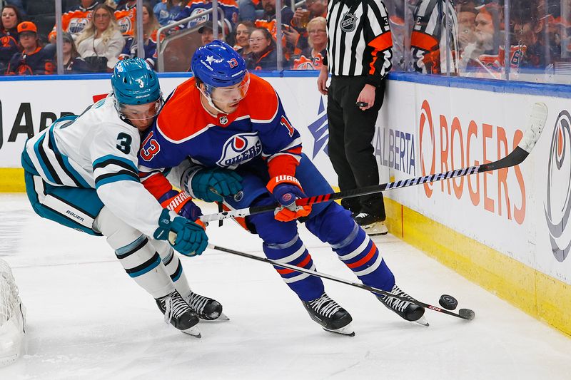 Apr 15, 2024; Edmonton, Alberta, CAN; Edmonton Oilers forward Mattias Janmark (13) and San Jose Sharks defensemen Henry Thrun (3) battle along the boards for a loose puck during the third period at Rogers Place. Mandatory Credit: Perry Nelson-USA TODAY Sports