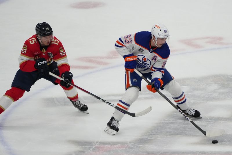 Jun 24, 2024; Sunrise, Florida, USA; Edmonton Oilers forward Ryan Nugent-Hopkins (93) controls the puck against Florida Panthers forward Anton Lundell (15) during the first period in game seven of the 2024 Stanley Cup Final at Amerant Bank Arena. Mandatory Credit: Jim Rassol-USA TODAY Sports