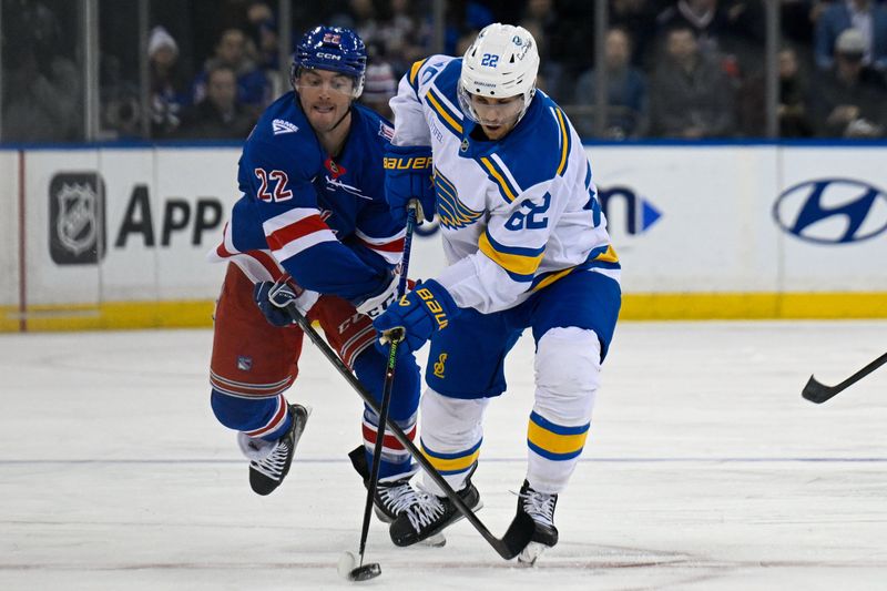 Nov 24, 2025; New York, New York, USA; New York Rangers center Jonny Brodzinski (22) defends against St. Louis Blues center Pius Suter (22) during the second period at Madison Square Garden. Mandatory Credit: Dennis Schneidler-Imagn Images