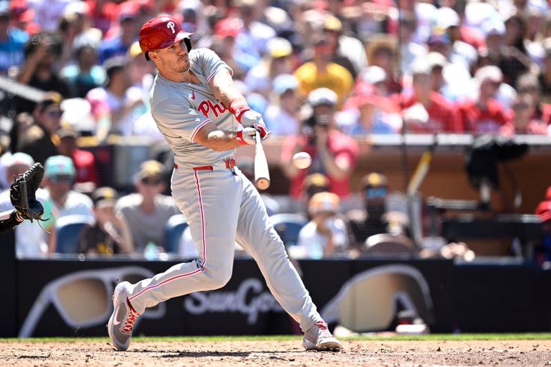 Apr 28, 2024; San Diego, California, USA; Philadelphia Phillies catcher J.T. Realmuto (10) hits an RBI single against the San Diego Padres during the seventh inning at Petco Park. Mandatory Credit: Orlando Ramirez-USA TODAY Sports