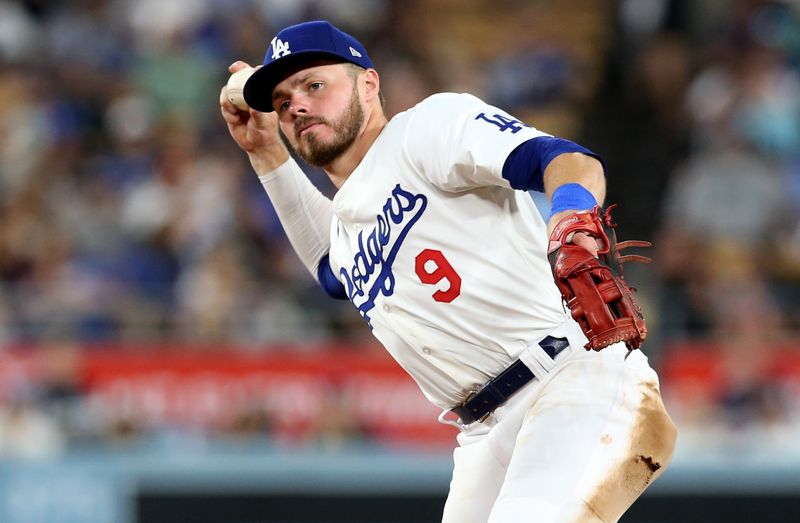 Jul 23, 2024; Los Angeles, California, USA; Los Angeles Dodgers second baseman Gavin Lux (9) throws to first for an out during the fourth inning against the San Francisco Giants at Dodger Stadium. Mandatory Credit: Jason Parkhurst-USA TODAY Sports