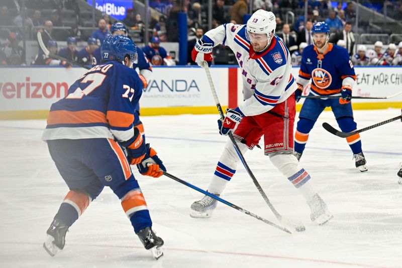 Jan 28, 2026; Elmont, New York, USA;  New York Rangers left wing Alexis Lafrenière (13) attempts a shot defended by New York Islanders defenseman Tony DeAngelo (77) during the first period at UBS Arena. Mandatory Credit: Dennis Schneidler-Imagn Images