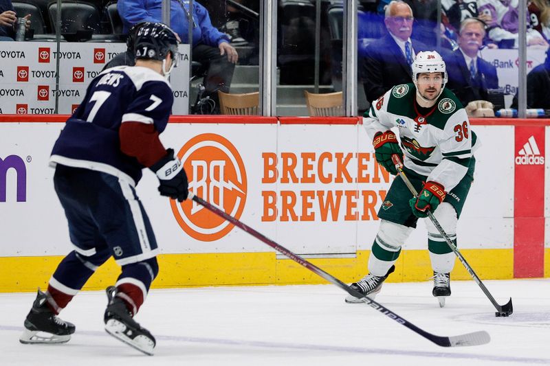 Apr 9, 2024; Denver, Colorado, USA; Minnesota Wild right wing Mats Zuccarello (36) controls the puck as Colorado Avalanche defenseman Devon Toews (7) defends in the third period at Ball Arena. Mandatory Credit: Isaiah J. Downing-USA TODAY Sports