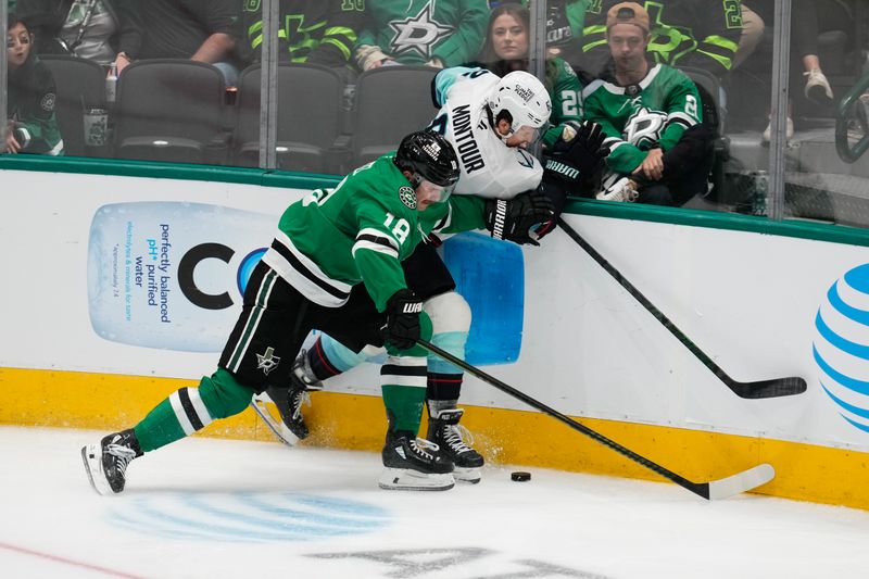 Oct 13, 2024; Dallas, Texas, USA;  Dallas Stars center Sam Steel (18) and Seattle Kraken defenseman Brandon Montour (62) battle for the puck during the third period at American Airlines Center. Mandatory Credit: Chris Jones-Imagn Images