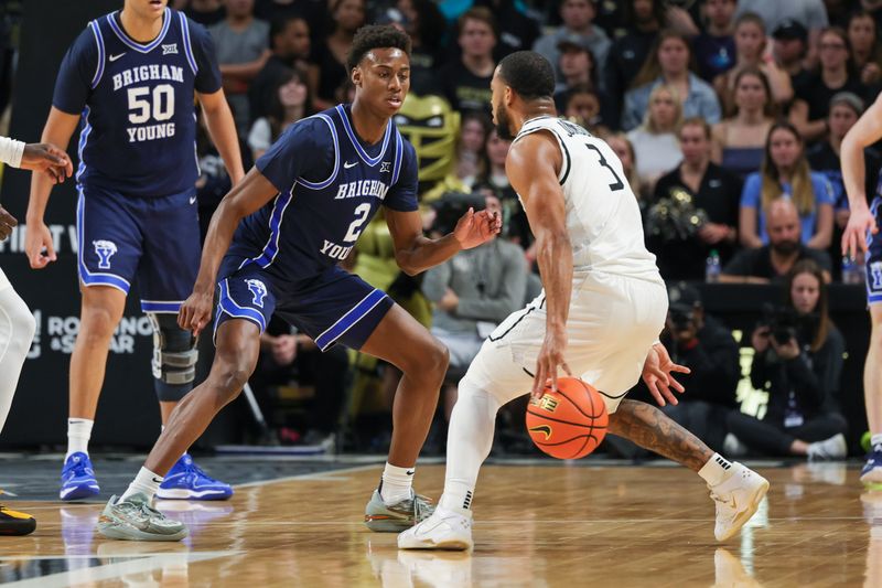 Jan 13, 2024; Orlando, Florida, USA; UCF Knights guard Darius Johnson (3) handles the ball in front of Brigham Young Cougars guard Jaxson Robinson (2) during the first period at Addition Financial Arena. Mandatory Credit: Mike Watters-USA TODAY Sports