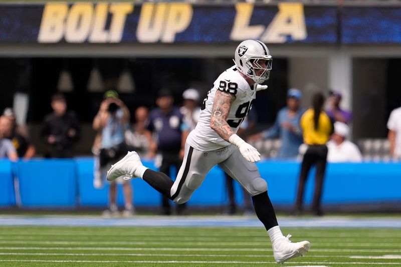 Las Vegas Raiders defensive end Maxx Crosby (98) reacts after sacking Los Angeles Chargers quarterback Justin Herbert during the first half of an NFL football game, Sunday, Sept. 8, 2024, in Inglewood, Calif. (AP Photo/Marcio Jose Sanchez)