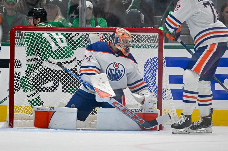 May 23, 2024; Dallas, Texas, USA; Dallas Stars center Sam Steel (18) shares behind Edmonton Oilers goaltender Stuart Skinner (74) during the first period in game one of the Western Conference Final of the 2024 Stanley Cup Playoffs at American Airlines Center. Mandatory Credit: Jerome Miron-USA TODAY Sports