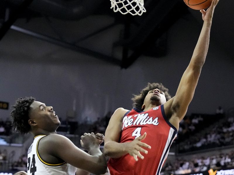 Mar 4, 2023; Columbia, Missouri, USA; Mississippi Rebels forward Jaemyn Brakefield (4) shoots a layup as Missouri Tigers guard Kobe Brown (24) defends during the second half at Mizzou Arena. Mandatory Credit: Denny Medley-USA TODAY Sports