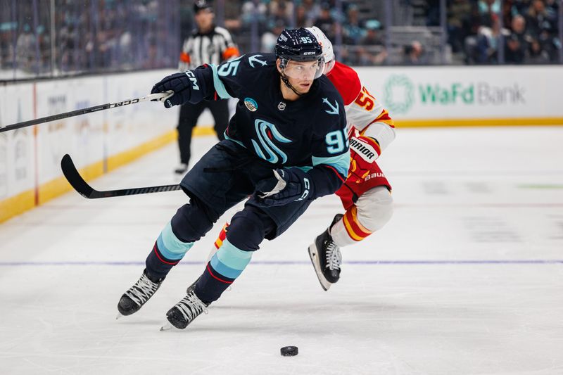 Oct 19, 2024; Seattle, Washington, USA; Seattle Kraken left wing Andre Burakovsky (95) skates against the Calgary Flames during the first period at Climate Pledge Arena. Mandatory Credit: Caean Couto-Imagn Images