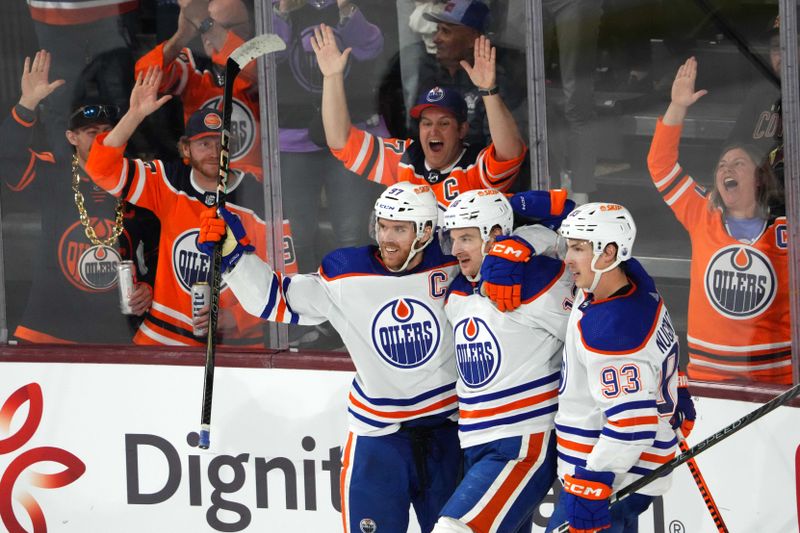 Feb 19, 2024; Tempe, Arizona, USA; Edmonton Oilers left wing Zach Hyman (18) celebrates his goal with Edmonton Oilers center Connor McDavid (97) and Edmonton Oilers center Ryan Nugent-Hopkins (93) against the Arizona Coyotes  during the third period at Mullett Arena. Mandatory Credit: Joe Camporeale-USA TODAY Sports