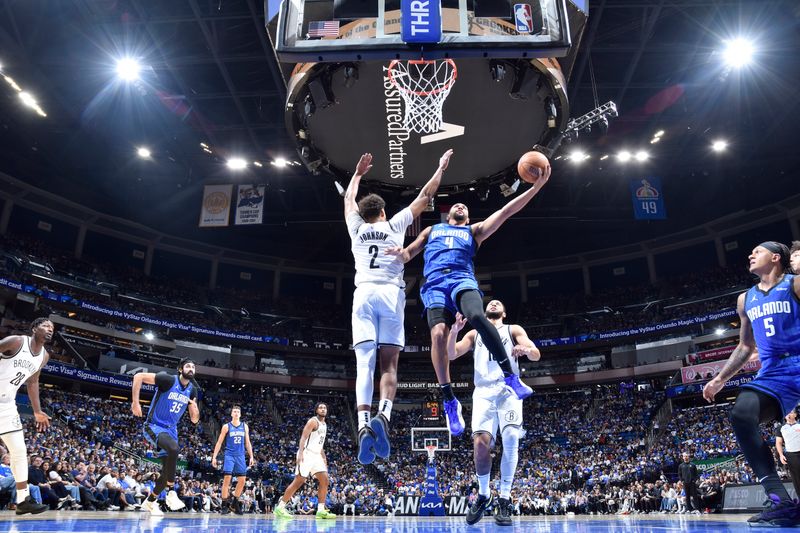 ORLANDO, FL - OCTOBER 25: Jalen Suggs #4 of the Orlando Magic drives to the basket during the game against the Brooklyn Nets on October 25, 2024 at Kia Center in Orlando, Florida. NOTE TO USER: User expressly acknowledges and agrees that, by downloading and or using this photograph, User is consenting to the terms and conditions of the Getty Images License Agreement. Mandatory Copyright Notice: Copyright 2024 NBAE (Photo by Fernando Medina/NBAE via Getty Images)