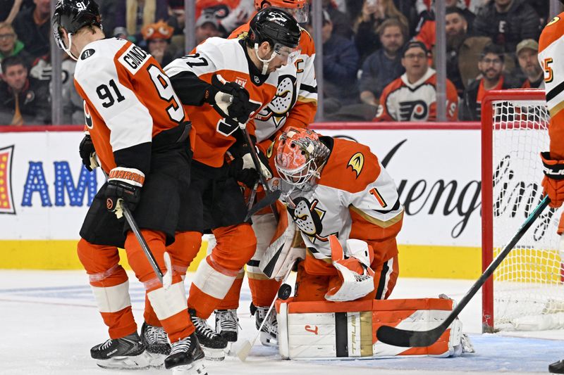 Jan 6, 2026; Philadelphia, Pennsylvania, USA; Anaheim Ducks goaltender Lukas Dostal (1) makes a save as Philadelphia Flyers left wing Noah Cates (27) looks for the rebound during the second period at Xfinity Mobile Arena. Mandatory Credit: Eric Hartline-Imagn Images