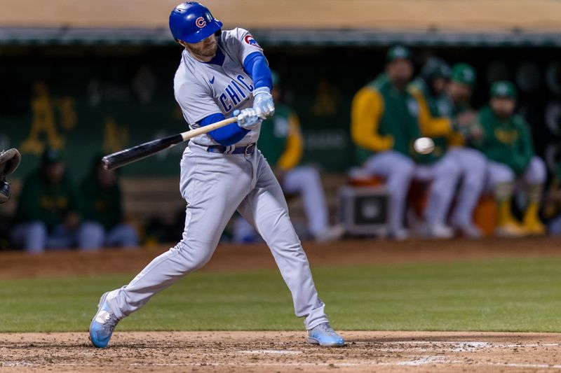 Apr 18, 2023; Oakland, California, USA; Chicago Cubs left fielder Ian Happ (8) hits a single against the Oakland Athletics during the fifth inning at RingCentral Coliseum. Mandatory Credit: John Hefti-USA TODAY Sports