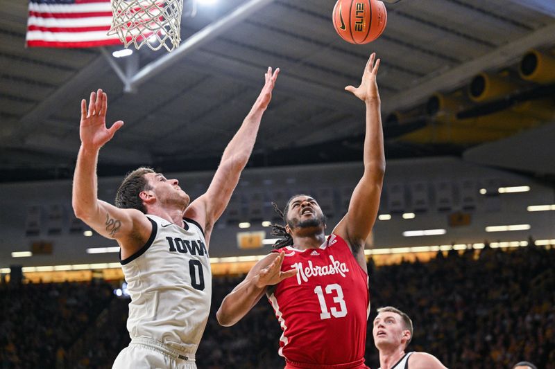 Mar 5, 2023; Iowa City, Iowa, USA; Nebraska Cornhuskers forward Derrick Walker (13) goes to the basket as Iowa Hawkeyes forward Filip Rebraca (0) defends during the first half at Carver-Hawkeye Arena. Mandatory Credit: Jeffrey Becker-USA TODAY Sports