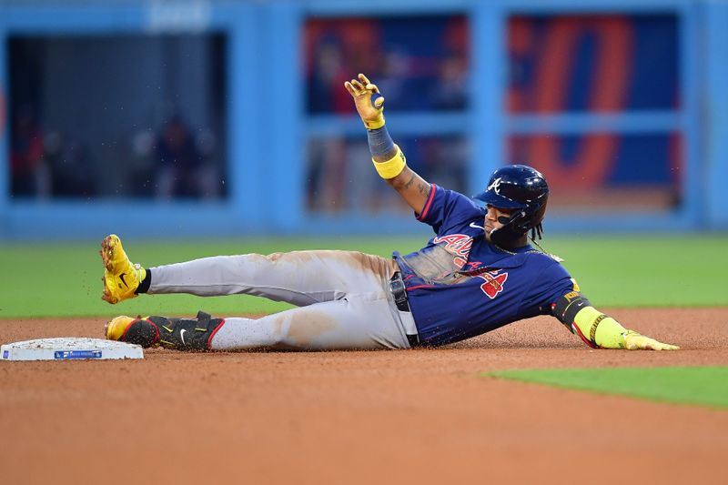 May 4, 2024; Los Angeles, California, USA; Atlanta Braves right fielder Ronald Acuña Jr. (13) reaches second on a double against the Los Angeles Dodgers during the sixth inning at Dodger Stadium. Mandatory Credit: Gary A. Vasquez-USA TODAY Sports