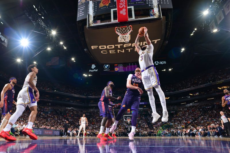 PHOENIX, AZ - FEBRUARY 25: Anthony Davis #3 of the Los Angeles Lakers grabs a rebound during the game against the Phoenix Suns on February 25, 2024 at Footprint Center in Phoenix, Arizona. NOTE TO USER: User expressly acknowledges and agrees that, by downloading and or using this photograph, user is consenting to the terms and conditions of the Getty Images License Agreement. Mandatory Copyright Notice: Copyright 2024 NBAE (Photo by Kate Frese/NBAE via Getty Images)