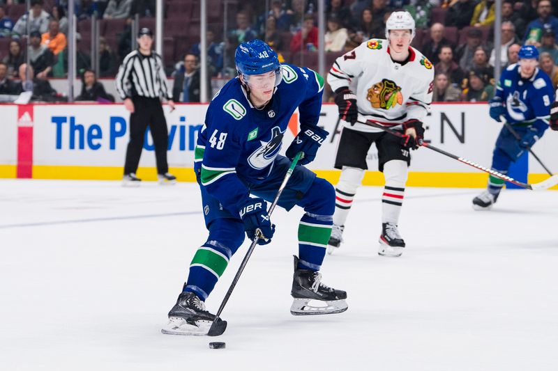 Apr 6, 2023; Vancouver, British Columbia, CAN; Vancouver Canucks defenseman Cole McWard (48) handles the puck against the Chicago Blackhawks in the third period at Rogers Arena. Canucks won 3-0. Mandatory Credit: Bob Frid-USA TODAY Sports