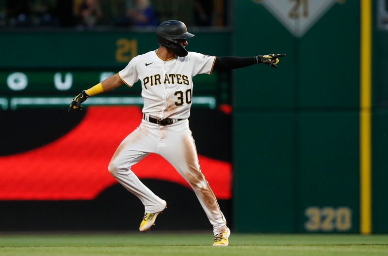 May 22, 2023; Pittsburgh, Pennsylvania, USA;  Pittsburgh Pirates shortstop Tucupita Marcano (30) reacts as he circles the bases on a grand slam home run against the Texas Rangers during the seventh inning at PNC Park. Mandatory Credit: Charles LeClaire-USA TODAY Sports