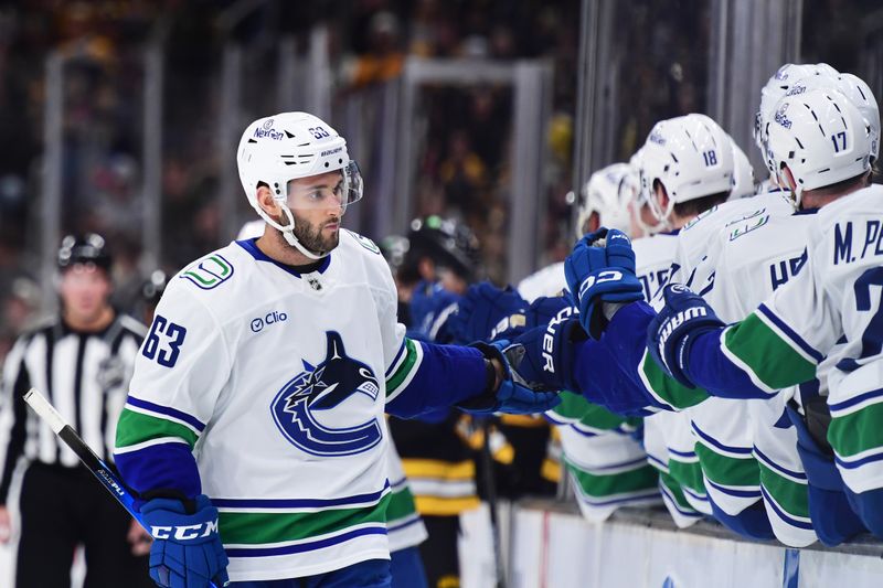 Dec 20, 2025; Boston, Massachusetts, USA;  Vancouver Canucks center Max Sasson (63) celebrates scoring a goal with teammates during the first period against the Boston Bruins at TD Garden. Mandatory Credit: Bob DeChiara-Imagn Images
