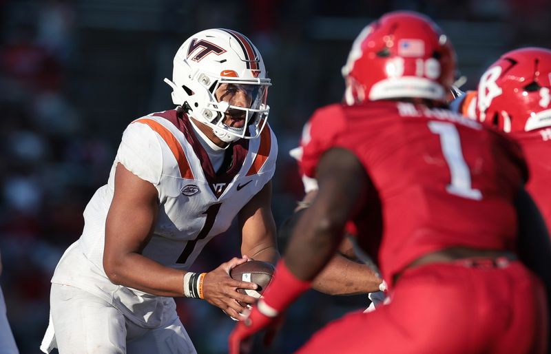 Sep 16, 2023; Piscataway, New Jersey, USA; Virginia Tech Hokies quarterback Kyron Drones (1) fakes a hand off as Rutgers Scarlet Knights linebacker Mohamed Toure (1) and defensive lineman Kyonte Hamilton (48) pursue during the second half at SHI Stadium. Mandatory Credit: Vincent Carchietta-USA TODAY Sports