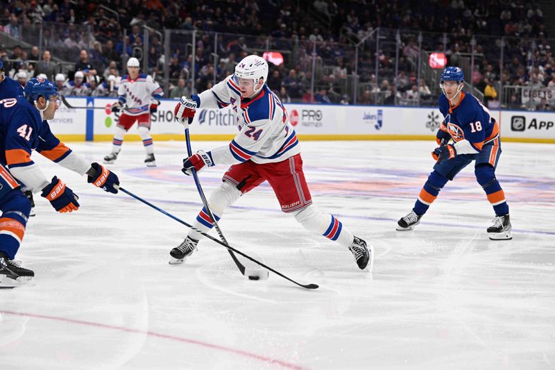 Apr 9, 2024; Elmont, New York, USA; New York Rangers right wing Kaapo Kakko (24) attempts a shot against the New York Islanders during the third period at UBS Arena. Mandatory Credit: Dennis Schneidler-USA TODAY Sports