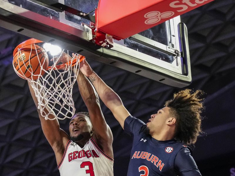 Jan 4, 2023; Athens, Georgia, USA; Georgia Bulldogs guard Kario Oquendo (3) dunks against Auburn Tigers guard Tre Donaldson (3) during the second half at Stegeman Coliseum. Mandatory Credit: Dale Zanine-USA TODAY Sports