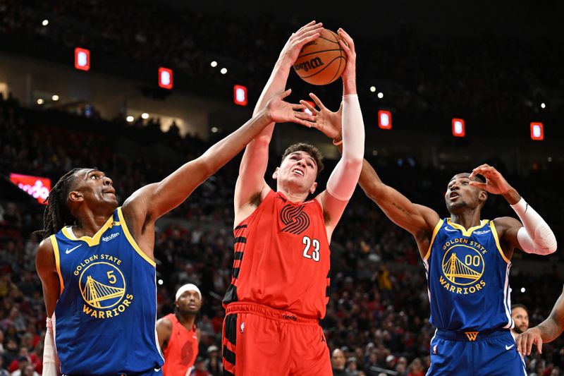 PORTLAND, OREGON - OCTOBER 23: Donovan Clingan #23 of the Portland Trail Blazers rebounds the ball against Kevon Looney #5 and Jonathan Kuminga #00 of the Golden State Warriors during the second quarter at Moda Center on October 23, 2024 in Portland, Oregon. NOTE TO USER: User expressly acknowledges and agrees that, by downloading and or using this photograph, User is consenting to the terms and conditions of the Getty Images License Agreement. (Photo by Alika Jenner/Getty Images)